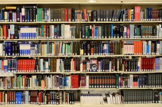 a shelf full of books at a library.